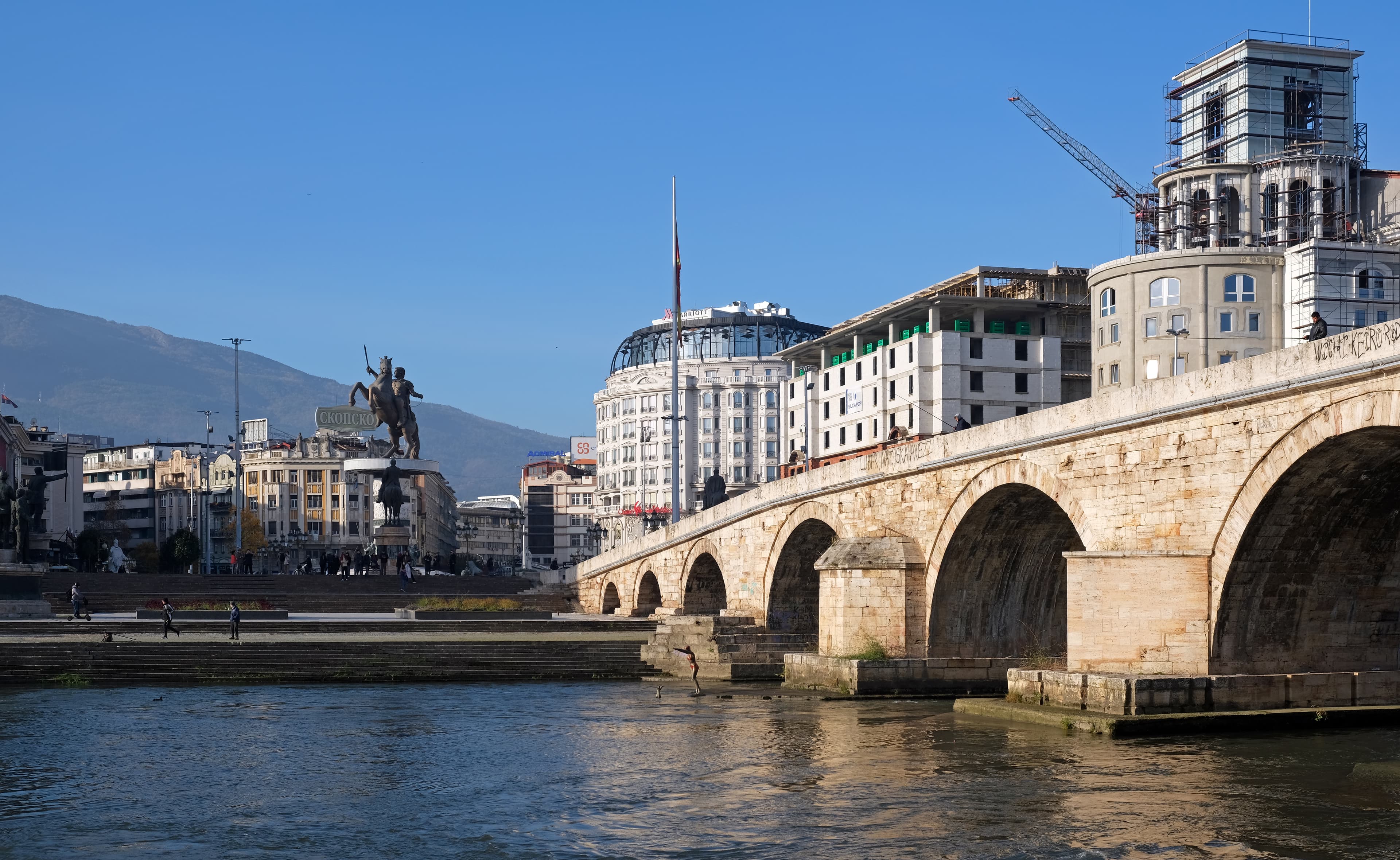 Skopje cityscape with Stone Bridge and historic architecture.