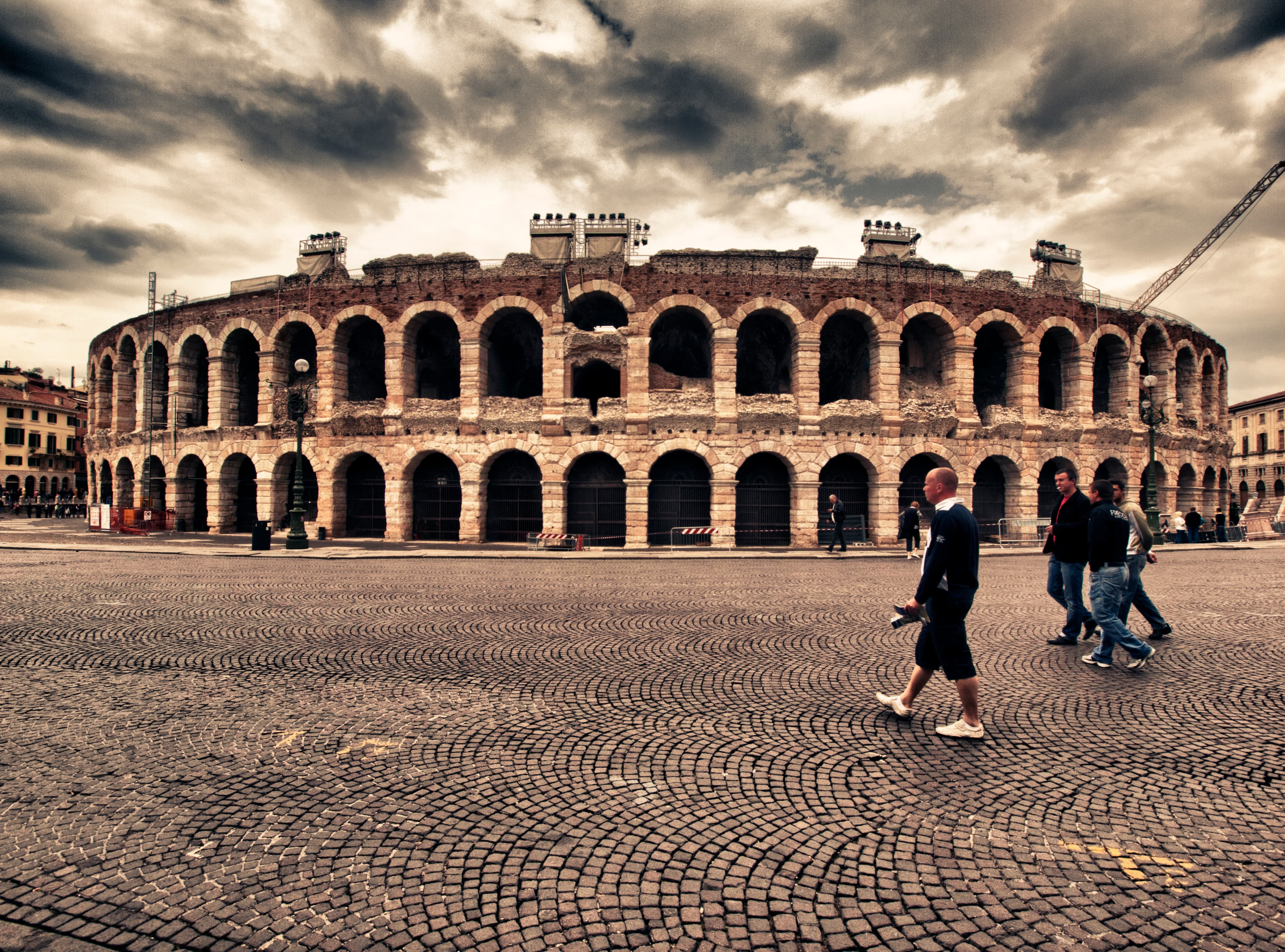 Verona Arena and historic rooftops at golden hour.