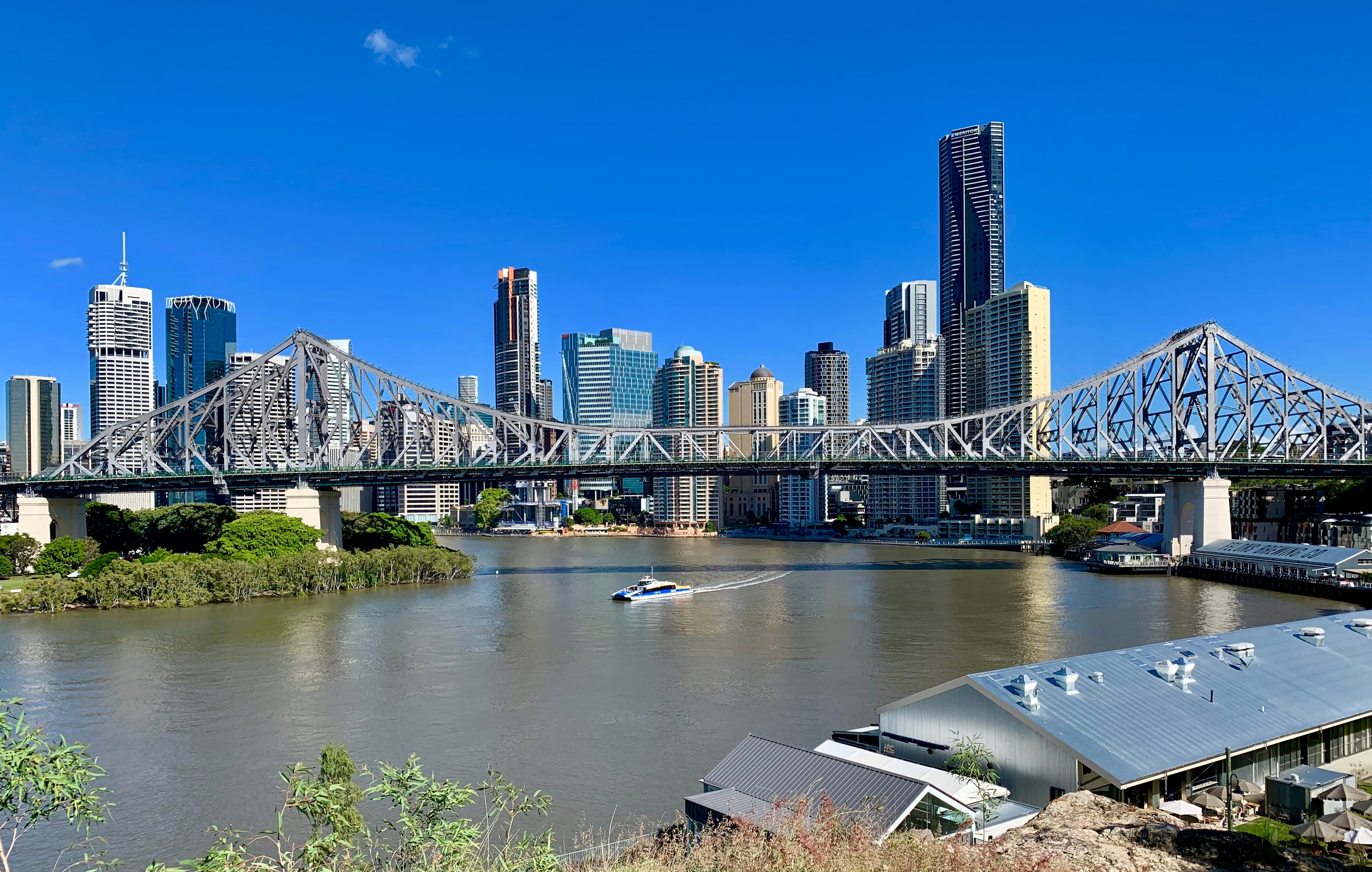 Brisbane Story Bridge and city skyline along the river.